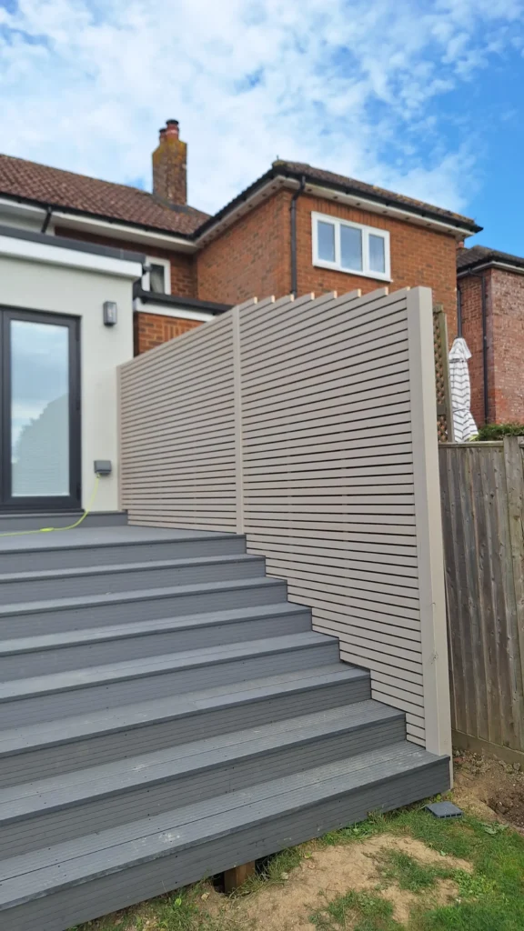 Bespoke contemporary garden fencing in Battle, featuring a continuous run of horizontal timber slats with a painted finish for modern privacy.