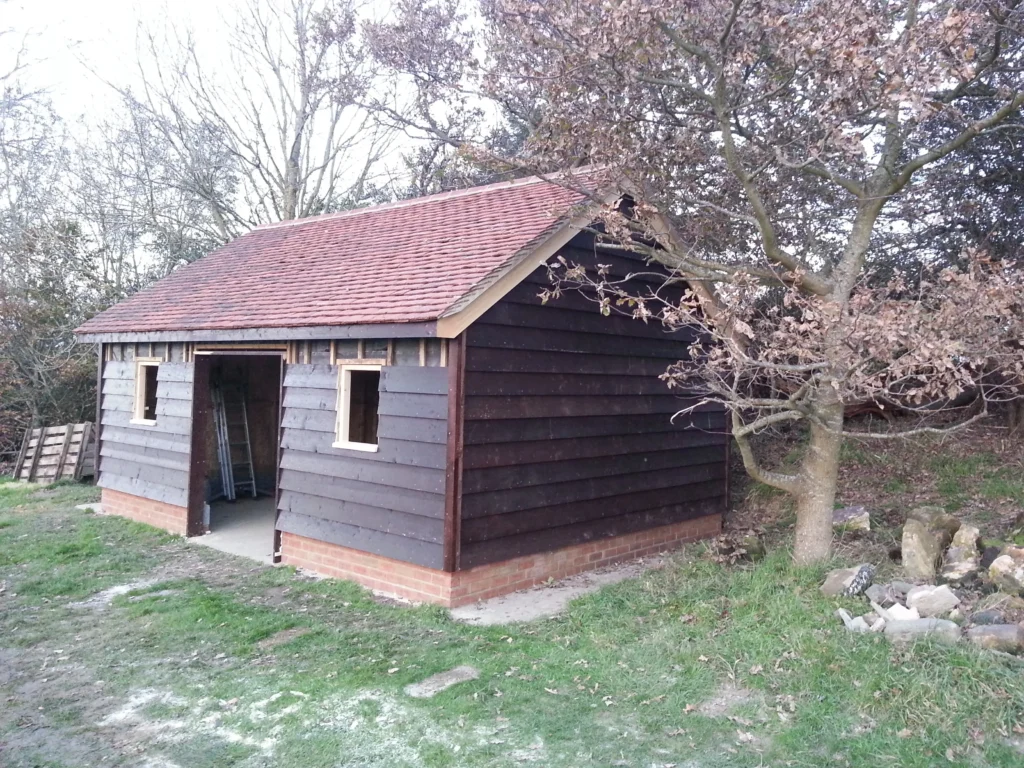 View of the outbuilding with cladding almost complete and the scaffold gone