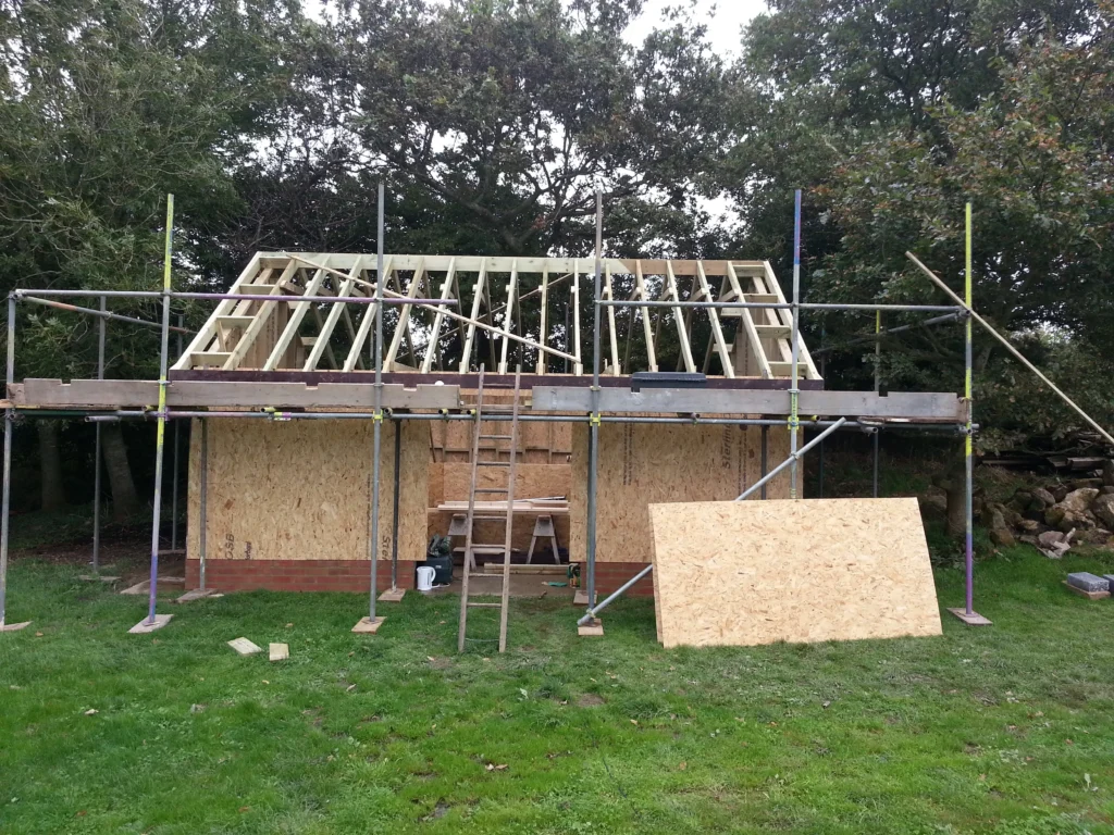 The full structural timber skeleton of the garden room, including the roof structure, prior to tiling and cladding.