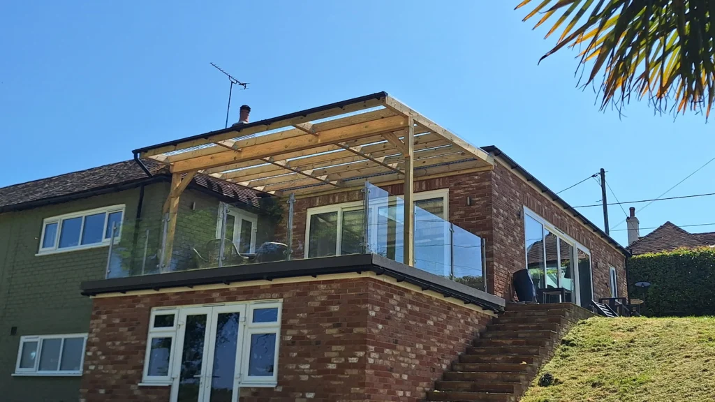 The completed 6x2 timber pergola structure, featuring clear corrugated roofing for weatherproofing while maintaining natural light on the balcony.